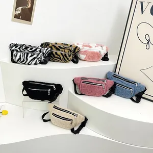 Plush lamb wool fanny packs in zebra and cow patterns on a white display stand