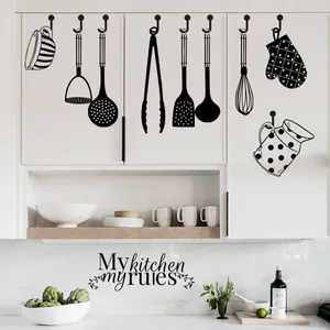 Detail showing 'My kitchen my rules' vinyl wall decals with black utensil icons for home