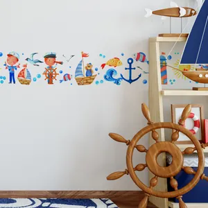 Detailed view of nautical wall border with cartoon ships and whales on white walls