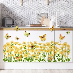 Yellow daisy flowers and 3D butterfly wall stickers on a white kitchen cabinet