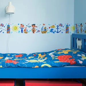 Detail of nautical wall border decal with cartoon sailboat lighthouse and anchor motifs