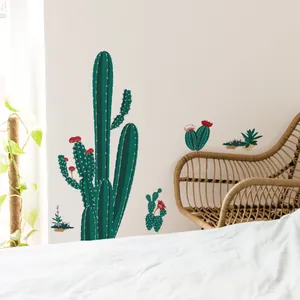 Detail of self-adhesive cactus wall stickers arranged above a wicker chair in a bedroom