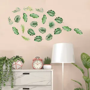 Tropical green leaf wall stickers applied to a bedroom wall in a cozy home setting