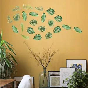 Tropical green leaves wall stickers featuring monstera and palm leaves on a warm wall
