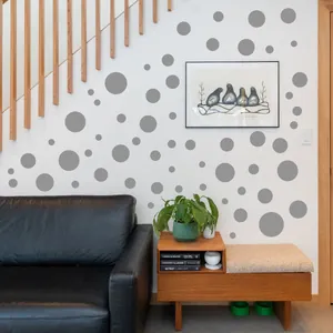 Detail of multi-size grey polka dot wall decals on a modern Nordic style living room wall