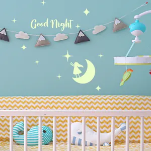 Glow-in-the-dark moon and stars wall stickers with Good Night lettering in nursery