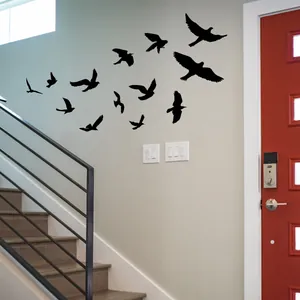 Set of 13 black bird wall stickers in various flight poses for modern home wall decor