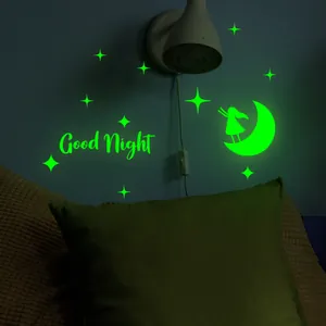 Luminous Good Night wall stickers with moon and stars glowing in a dark bedroom
