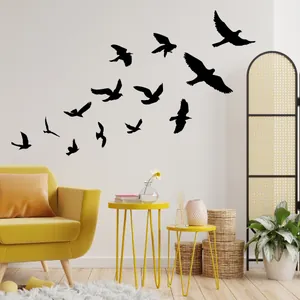 Modern black bird silhouette wall decals flying over a yellow sofa in a living room
