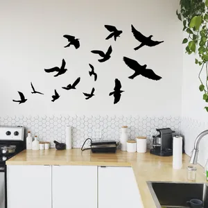 Set of black bird silhouette wall decals arranged on a modern white kitchen wall décor