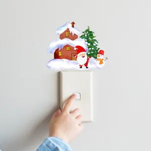 Sticker mural de Noël avec Père Noël et bonhomme de neige sur un interrupteur