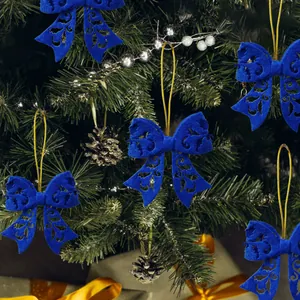 Blue felt butterfly Christmas tree ornament with intricate cutout patterns and gold string