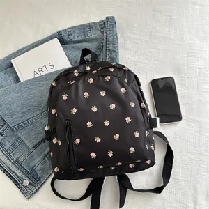 Floral print black nylon backpack with pink flowers for casual outdoor activities