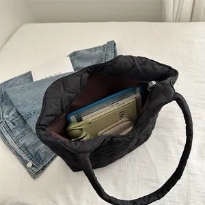 Black large capacity quilted tote bag showing spacious interior with daily essentials