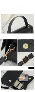 Close-up of matte black leather handbag with gold metal hardware and reinforced handle
