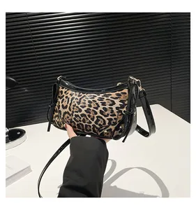 Detail of leopard print shoulder bag with black patent trim and gold-tone hardware