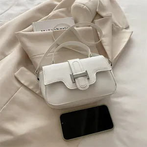 Chic white leather crossbody bag with silver buckle and phone for size reference