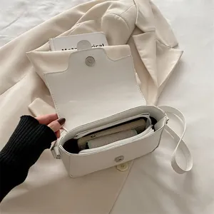 Minimalist beige leather shoulder bag for women with spacious interior and zipper pocket