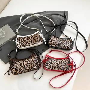 Chic leopard print crossbody bags in various colors featuring metal studs and side ties