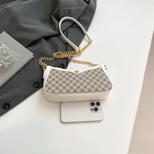 Fashionable monogram baguette bag with white leather trim and gold chain detail