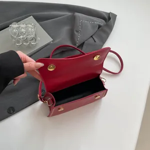 Elegant red square leather handbag with decorative stitching and metallic buckle for women