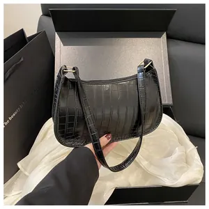 Detail of black faux crocodile leather baguette bag in a premium black gift box set