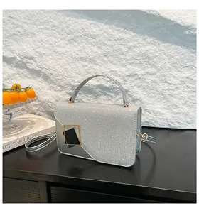 Close-up of the silver woven texture and glitter finish on this elegant mini square bag
