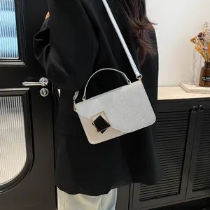 Chic silver sequin handbag for women with a gold buckle shown as a crossbody bag