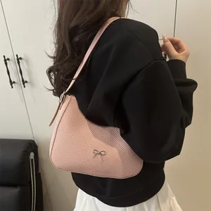 Pink crescent hobo bag with silver metallic bow and textured woven finish for women