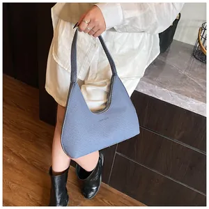 Close-up of Morandi blue textured hobo bag with zip closure and minimalist design