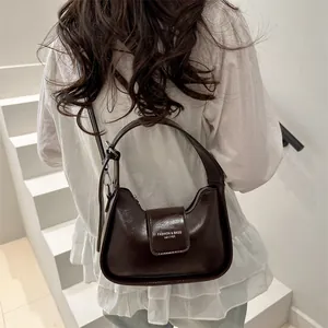 Deep brown leather saddle shoulder bag with chain lock and adjustable strap
