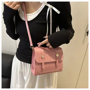 Close-up of pink PU leather crossbody bag with metal buckle and vintage square design