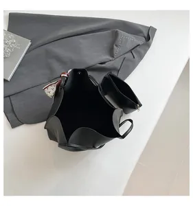 Detail view of black tote bag set with matching pouch and decorative printed silk scarf