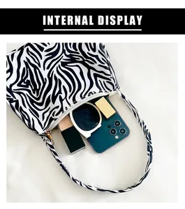 Internal view of zebra print shoulder bag showing space for phone and makeup