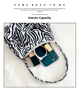 Macro view of zebra print canvas bag interior showing space for smartphone and makeup