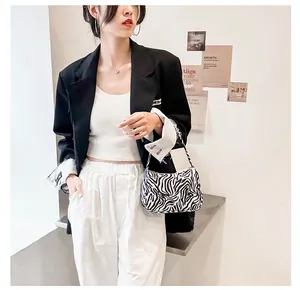 Zebra print baguette bag styled with a blazer showing professional fashion details
