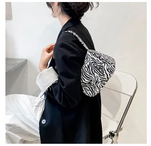 Close-up of zebra pattern shoulder bag with sleek faux leather finish for daily wear