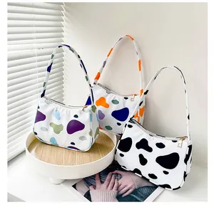 Three-piece set of nylon leopard and cow print shoulder bags with golden zipper closure
