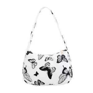 Chic butterfly print half-moon hobo bag with gold zipper and white canvas shoulder strap