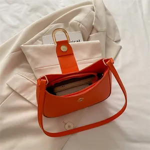Orange PU leather underarm bag with gold U-shaped handle and magnetic clasp closure