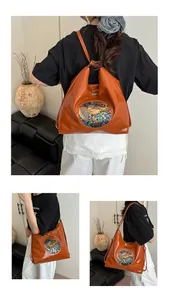 Detail of vintage orange-brown faux leather tote bag with ethnic elephant pattern patch
