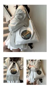 Detail of vintage embossed elephant pattern on off-white large capacity tote bag