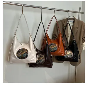 Detailed display of vintage hobo tote bags in four classic colors with metal relief decor