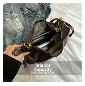 Macro view showing the internal capacity and herringbone lining of the dark brown tote bag