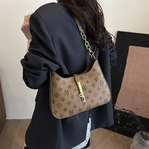 Brown monogram underarm bag with vintage print, gold buckle, and chain strap for women