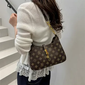 Classic dark brown monogram underarm bag with gold chain strap and lock closure