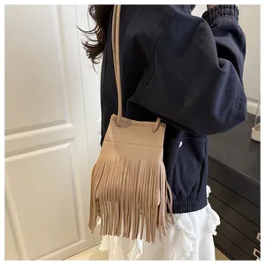 Detail der khakifarbenen Fransen-Beuteltasche aus Leder mit Model-Styling und Gurt