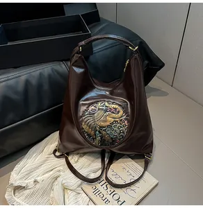 Detail of vintage embossed pattern on premium brown leather backpack with metallic accents