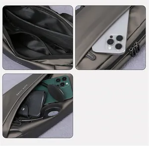 Detail view of multi-compartment grey sling bag showing internal pockets and zippers