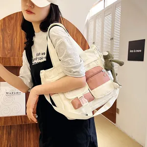 Large beige and pink canvas tote bag with adjustable strap and green frog plush pendant